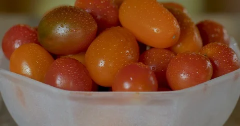Cherry tomatoes with drops of moisture in a bowl - tilt up Video stock 92736271