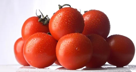 Cherry tomatoes with drops of water rotating on white background Stock Footage 122178288