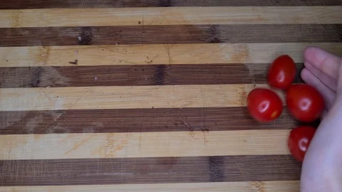 Cherry Tomatoes Falling And Rolling On A Table. Stock-Footage 165542614