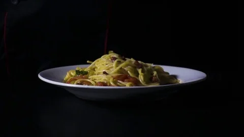 Cherry tomatoes falling into a bowl of pasta super slow mo Stock Footage 72432998