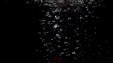 Cherry tomatoes falling into clear water with big splash on black background. Stock Footage 150567024