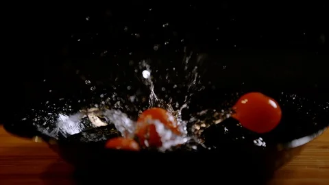 Cherry tomatoes falling on a plate, Ultra Slow Motion Stock Footage 86575772