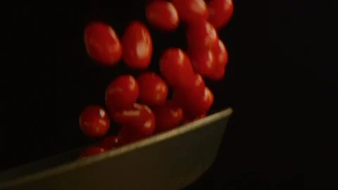 Cherry tomatoes falling in slow motion isolated Stock Footage 126259057