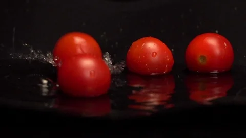 Cherry Tomatoes Falling into Water Stock Footage 122811613