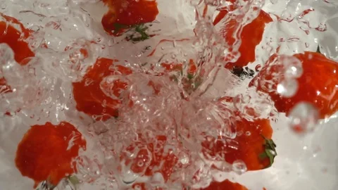 Cherry tomatoes falling into the water. Slow motion. Stock-Footage 127090847