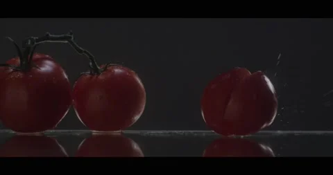 Cherry tomatoes falls on a mirror surface in slowmo Stock Footage 198146583