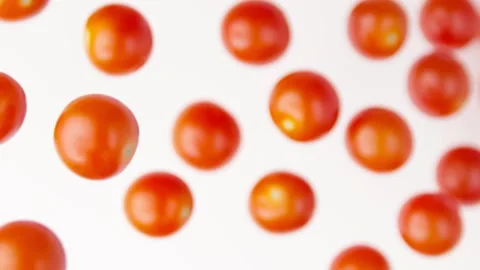 Cherry tomatoes flies in slow motion on the white background Video stock 148743084