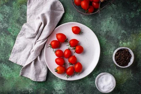 Cherry tomatoes on green background Stock Photos