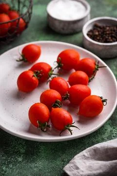 Cherry tomatoes on green background Stock Photos