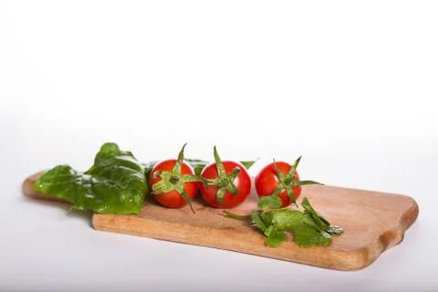 Cherry tomatoes on a kitchen board Stock Photos