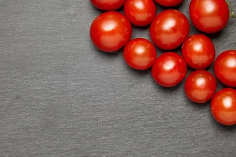 Cherry tomatoes over stone table. Stock Photos