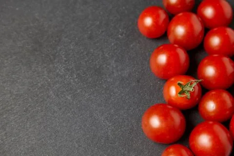 Cherry tomatoes over stone table. Stock Photos