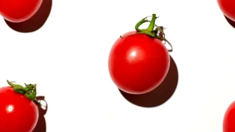 Cherry tomatoes over white background - camera zoom out Stock Footage 119672774