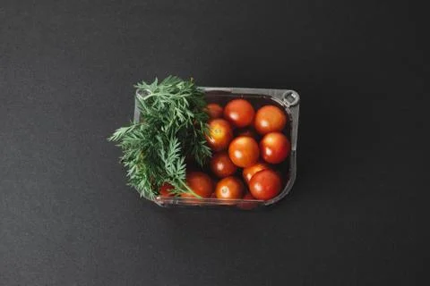 Cherry tomatoes in a plastic container. Top view Stock Photos