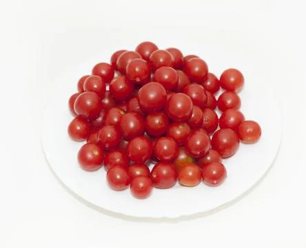 Cherry tomatoes in a plate on a white background Stock Photos