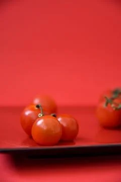Cherry tomatoes on a red plate. Stock Photos
