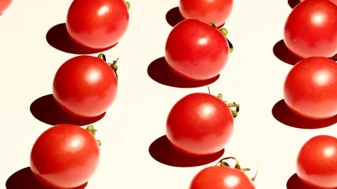 Cherry tomatoes rotating over white background Stock Footage 119771254