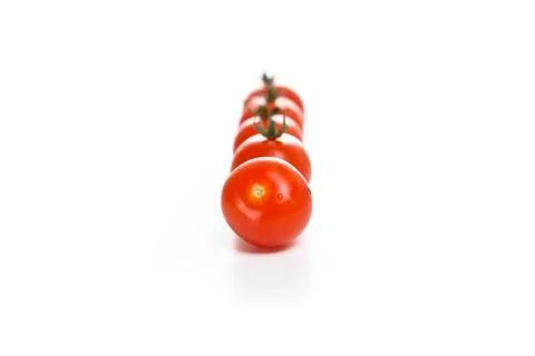 Cherry tomatoes in a row on a white background Stock Photos