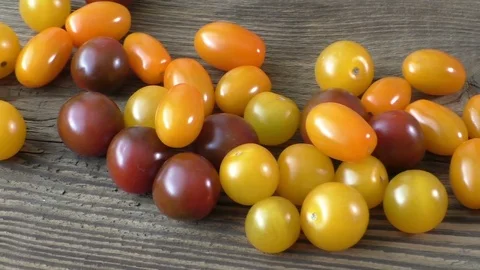 Cherry tomatoes on rustic wooden background Stock Footage 76652877