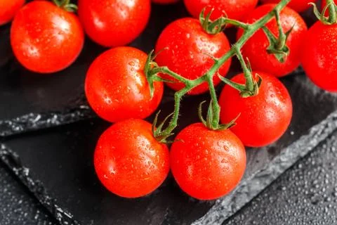 Cherry tomatoes on slate backgound Stock Photos