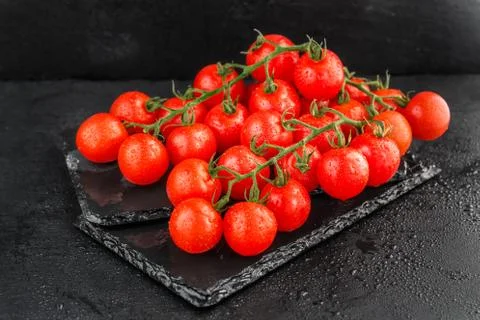 Cherry tomatoes on slate backgound Stock Photos