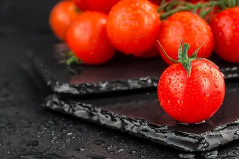 Cherry tomatoes on slate backgound Stock Photos