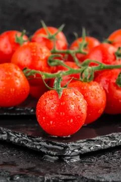 Cherry tomatoes on slate backgound Stock Photos