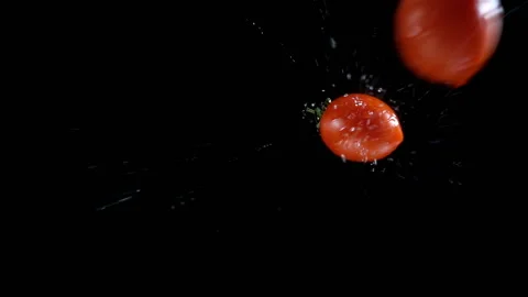 Cherry tomatoes slow motion fall on a wet black Stock Footage 133222532