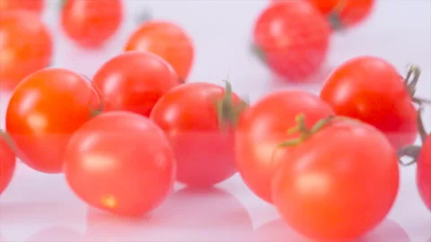 Cherry tomatoes in slow motion roll on camera Video stock 143114437