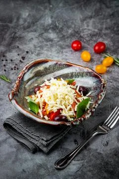 Cherry tomatoes, spinach, eel, lime, cheese, side view Stock Photos
