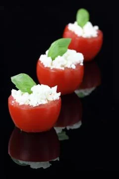 Cherry tomatoes stuffed with white cheese Stock Photos