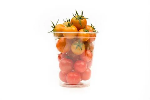 Cherry tomatoes in transparent plastic container on white background, close-u Stock Photos