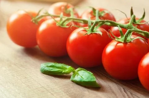 Cherry tomatoes on twigs close-up. Background, banner, splash Stock Photos