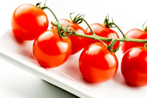 Cherry tomatoes on the vine Stock Photos