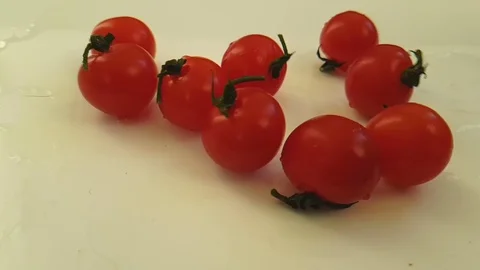 Cherry tomatoes wet on white background, slow motion Stock Footage 89711790