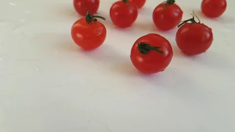 Cherry tomatoes on a white background falling slow motion Video stock 88000777