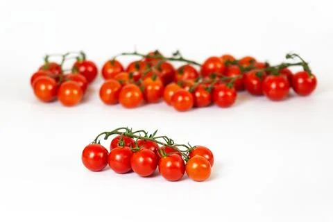 Cherry tomatoes on a white background. Stock Photos