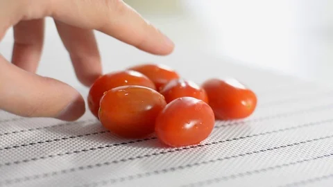Cherry tomatoes on a white table Stock Footage 124190532