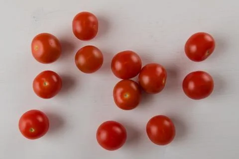 Cherry tomatoes on white table Stock Photos