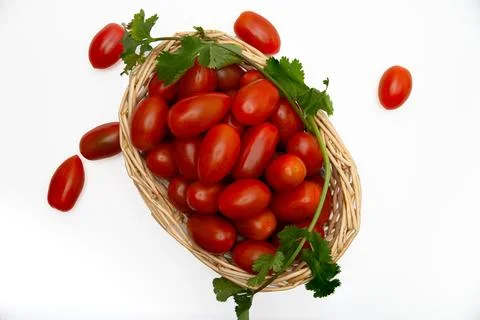 Cherry Tomatoes in a wicker basquet. Stock Photos