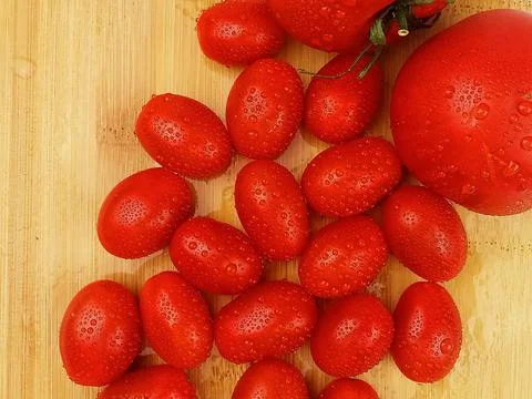 Cherry tomatoes on wooden board top view Stock Photos
