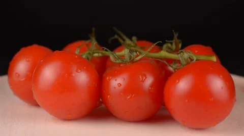Cherry tomatoes on wooden plate Stock Footage 65227876