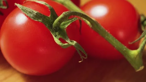 Cherry tomatoes on a wooden surface close-up Stock Footage 131443144