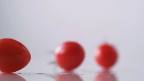 Cherry tomatos falling. Slow Motion. Stock Footage 79475202