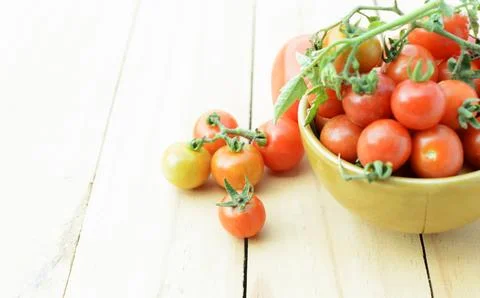 Cherry tomatos vegetable with select macro close up on wooden table backgroun Stock Photos