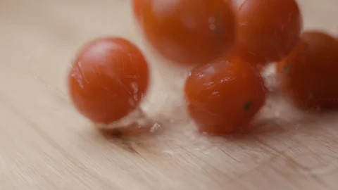 Cherry tomoatoes falling with water slow motion HD Stock Footage 113976037