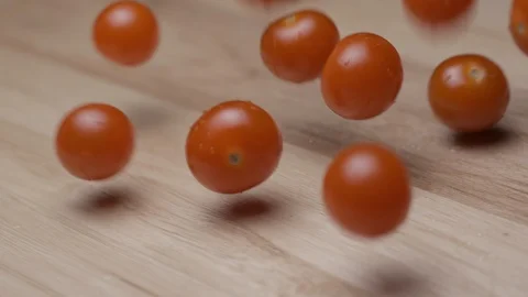Cherry tomoatoes falling with water slow motion HD Stock Footage 113976113