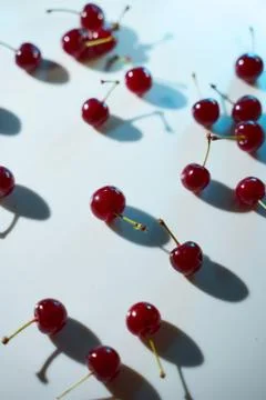 Cherry on a white background with blue highlights and shadows. Close-up. Top  Stock Photos