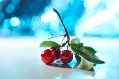 Cherry on a white background with blue highlights and shadows. Close-up. Top  Stock Photos