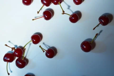 Cherry on a white background with blue highlights and shadows. Close-up. Top  Stock Photos